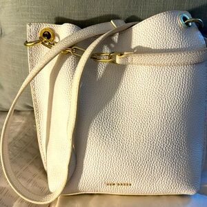 Ted Baker white with gold hardware, leather crossbody. Has magnetic closure.